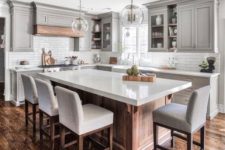 21 a modern farmhouse kitchen with a large kitchen island of wood and a white ston countertop that doubles as a dining table
