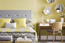 21 a pale yellow statement wall and matching pillows and a blanket for a colorful touch