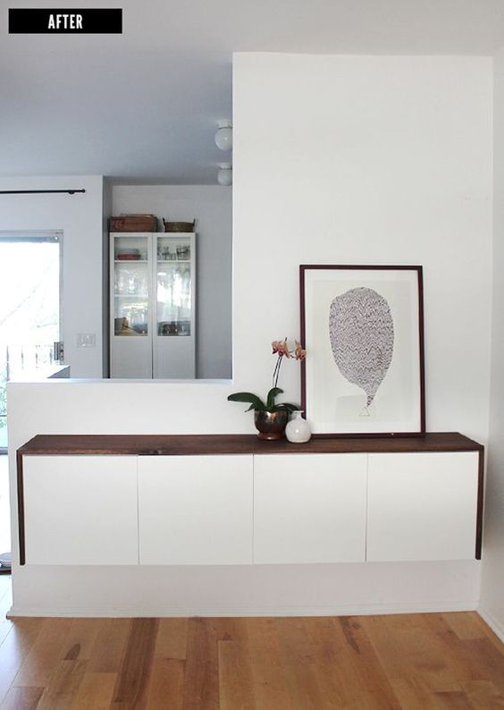 A stylish floating console of a white dresser with a dark stained tabletop is all you need for a contemporary entryway
