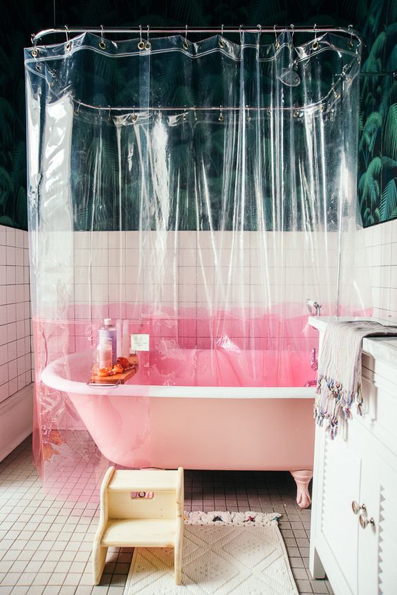 a transparent shower curtain with a pink color block element is a simple and catchy idea to try
