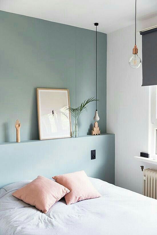 highlight your sleeping zone with a color block effect, paint just one headboard wall in some color, like here - muted green for a peaceful feel