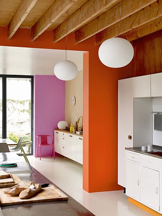 retro-inspired color blocking with a bold pink and orange wall for an accent and all neutrals around