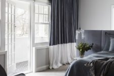 22 a monochromatic grey and white space with color blocking – a headboard wall and curtains