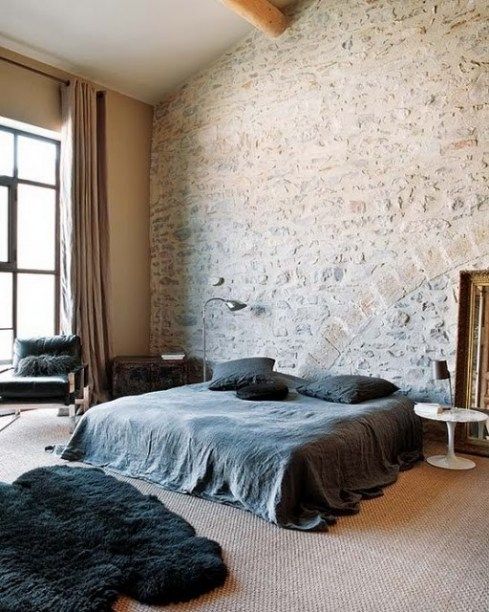 Add interest to your contemproray bedroom with a whitewashed stone accent wall