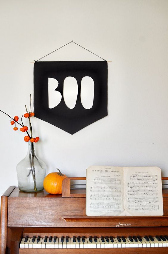 a simple BOO sign of black paper or fabric can be hung anywhere you want