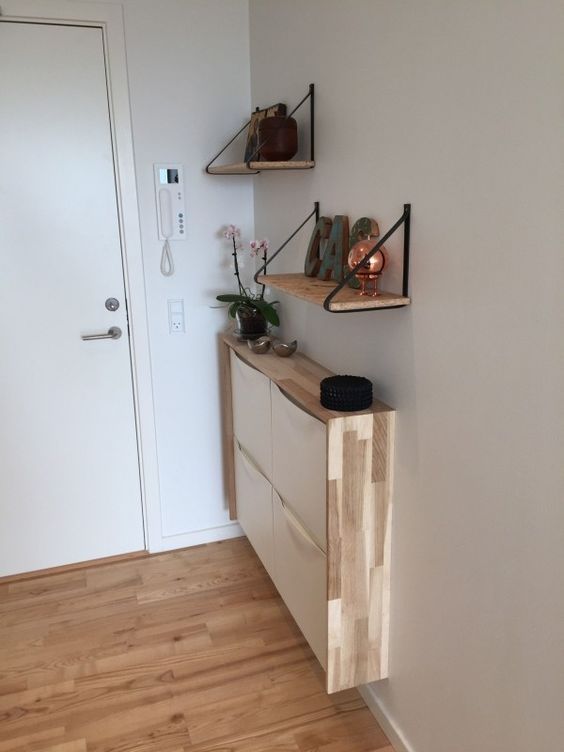 a very narrow floating console of an IKEA shoe cabinet with a plywood waterfall tabletop for a tiny entryway