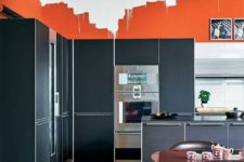 23 orange walls with a graphic effect create also a color block one with graphite grey cabinets