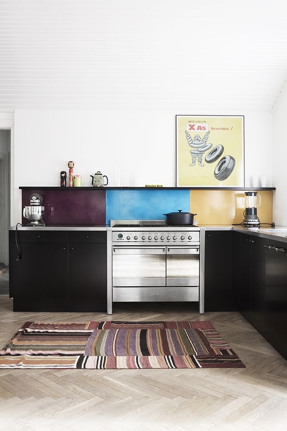 a black kitchen is spruced up with a bold idea, a color block kitchen backsplash