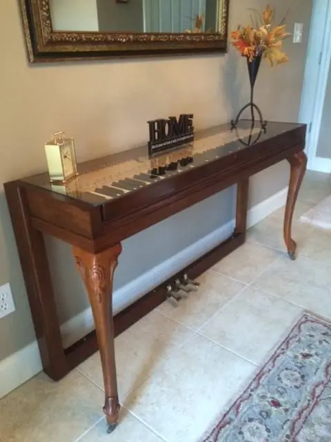 Wurlitzer piano with beautiful legs repurposed into a creative and chic console for an entryway