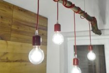 25 make a bold eco-style lamp using a tree branch, some colorful cord and bulbs for a bright look
