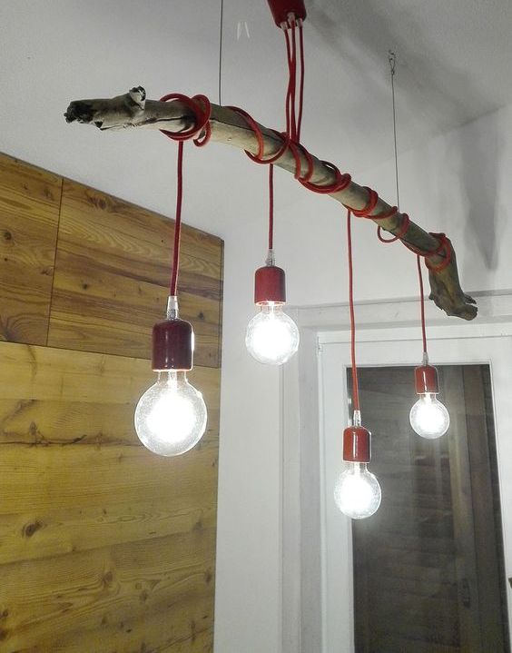Make a bold eco style lamp using a tree branch, some colorful cord and bulbs for a bright look