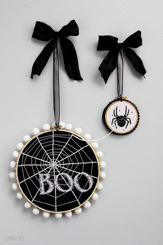 modern Halloween hoop art with spiderweb and a spider, pompoms and large bows