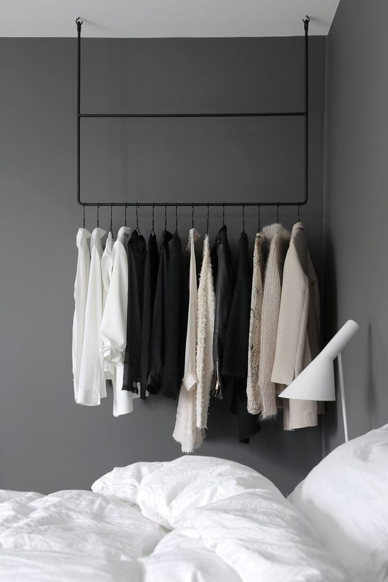 hang a rail to make your clothes part of your bedroom decor