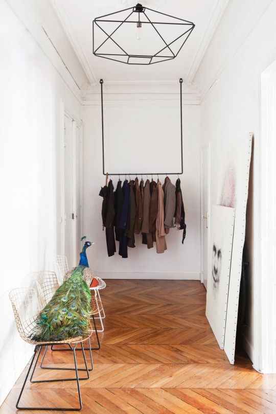 such a simple coat rack attached to the ceiling is a minimal and stylish solution to rock in a small space
