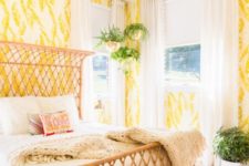 24 bold yellow and white wallpaper with botanical prints create a bright space and a wicker bed adds to it