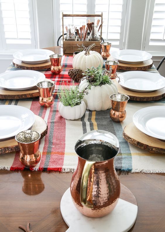 copper glasses of a whimsy shape and a matching pitcher spruce up the simple rustic tablescape