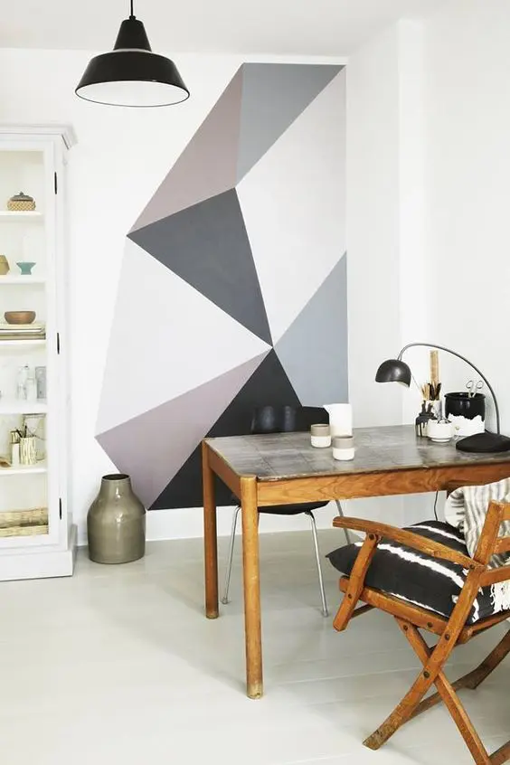 a cozy home office nook that is visually separated from the rest of the space with a geometric color block wall
