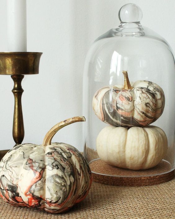 a cloche with a white and marbleized pumpkin is a fast and cute centerpiece you can make last minute