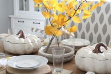 04 a cozy fall table setting with a fall leaf centerpiece, wood slice placemats and faux pumpkin salad bowls