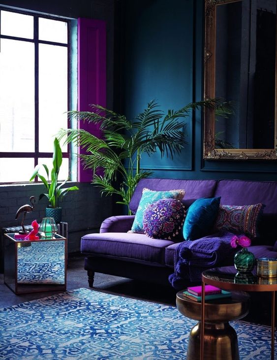 a moody space with jewel tones,metallic and mirror touches plus lush greenery for a bold look