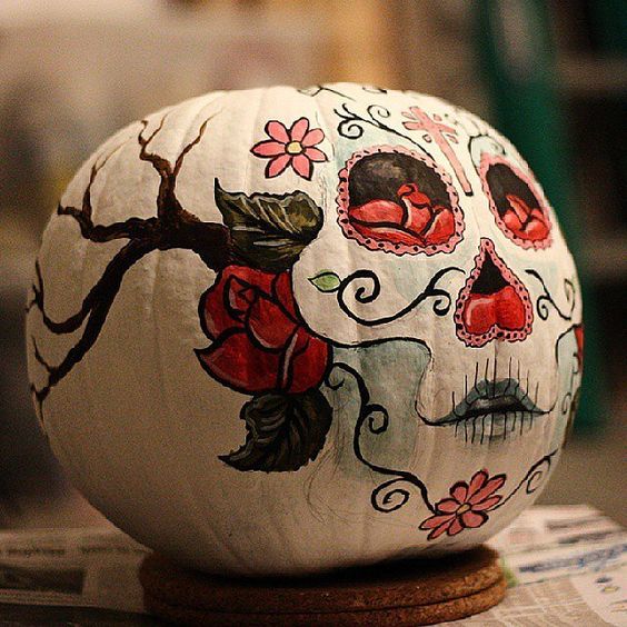 a pumpkin with a painted sugar skull is a nod at the Mexican holiday and a great boho idea for Halloween