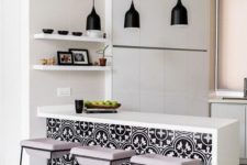 04 an all-white minimalist kitchen enlivened with bright black and white printed tiles on the kitchen island