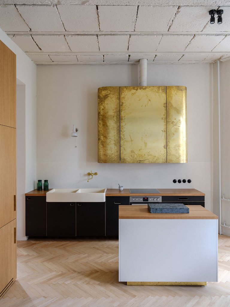 The kitchen is done with dark and light colored plywood cabinets and look at that gold leaf hood  isn't it a statement