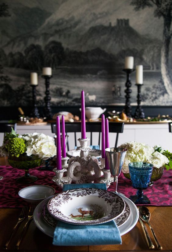 a bright Thanksgiving tablescape done with fuchsia and blue touches plus white hydrangeas and an elegant candelabra