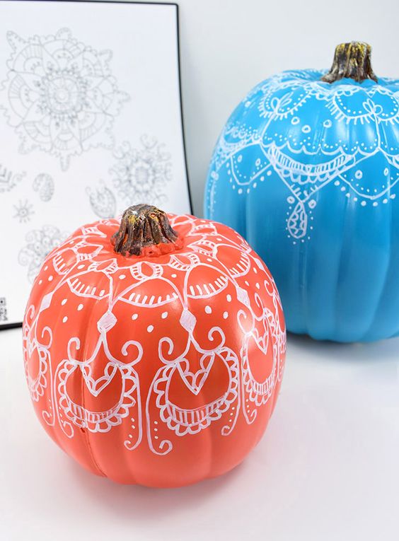 bright pumpkins with henna decor on them to add a colorful touch and a boho feel to the space