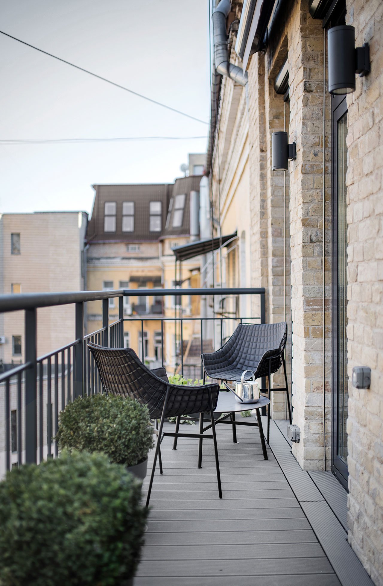 The small balcony features a little sitting space with a coffee table