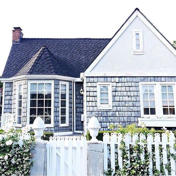 a beach cottage with shingles in a pale blue shade and a sweet garden is what you need
