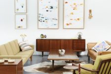 06 a bright mid-century modern living room with mustard colored furniture and abstract paintings