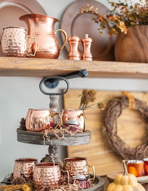 copper mugs and a pitcher are a great idea to create a chic Thanksgiving bar that invites