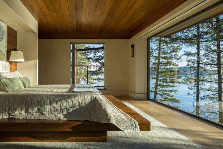 The master bedroom features an almost glazed wall and severla large windows, all done for amazing views