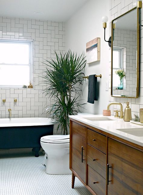a welcoming mid-century modern bathroom with geometric clad tiles and penny ones on the floor plus a palm tree