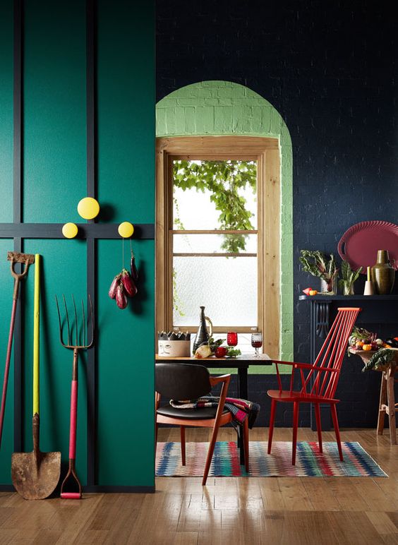 a bright space in emerald, black with red and yellow accens and a printed rug