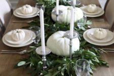 08 a neutral tablescape with white pumpkins, plates and candles and a fresh greenery table runner in the center