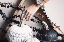08 an arrangement of black and white pumpkins with tribal patterns with usual and dried eucalyptus