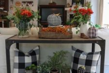 08 an industrial console with floral arrangements, fabric pumpkins, potted greenery and plaid pillows