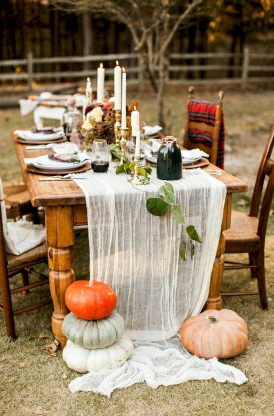 if you hestate about an airy table runner, just nail it with large heirloom pumpkins to make it secure on the table