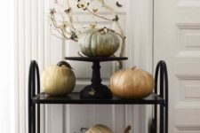 09 a black cart with pumpkins painted with pearly paint and whitewashed branches for Halloween