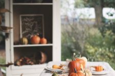09 a cozy and simple Thanksiving table setting with pumpkins and corns plus corn husks