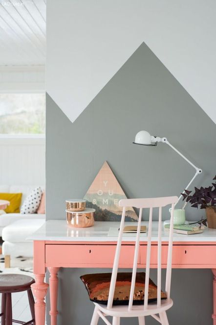 a home office nook with grey geometric color blocking and a coral desk for a colorful touch