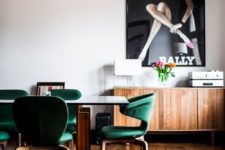 10 a mid-century modern dining room with emerald chairs with an oversized poster for a statement