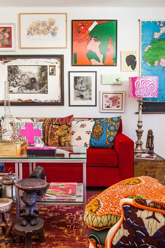 a colorful and bright living room with super bold artworks covering the whole wall
