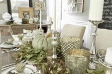 11 a cool table decorated with seeded eucalyptus, green pumpkins, mercury glass candle lanterns and candles
