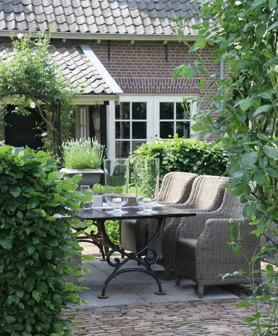 create an outdoor dining space with wicker furniture in your back patio to extend the living space and enjoy fresh air