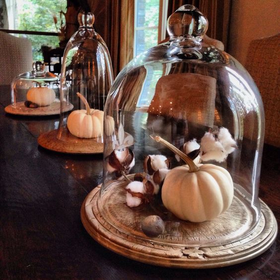 a rustic display with a vintage bread board, cotton branches and a white pumpkin won't take much time to make