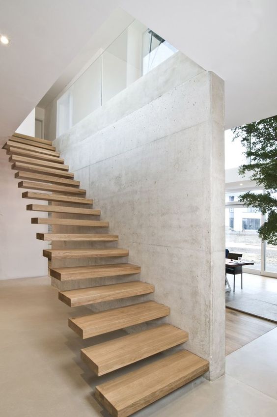 attaching the steps to the wall gives them really a floating and seamless look and concrete contrasts wood