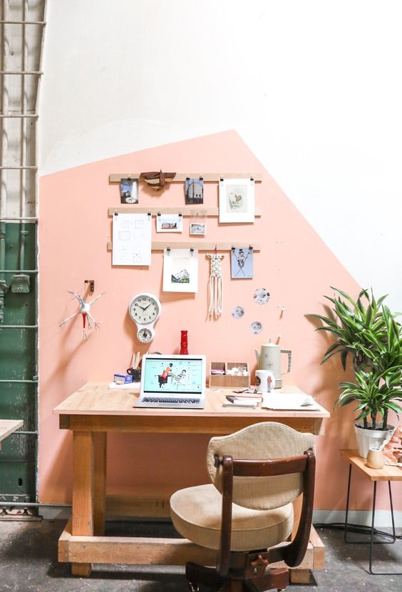 a modern home office and crafting space with a geometric color block wall in pink for a cute look